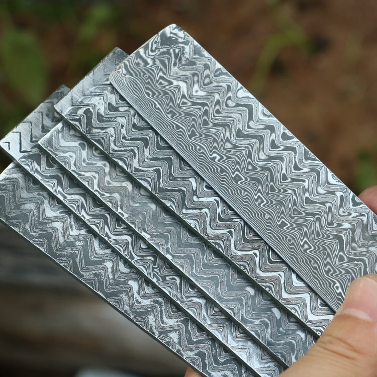 http://www.thecookingguild.com/cdn/shop/articles/0_Herringbone-stainless-damascus-steel-knife-diy-steel-knife-making-material-blade-steel-new-pattern-damascus-billet.jpg?v=1698362728