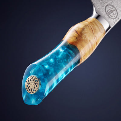 Close up of the Feather Forge Sapphire handle: burl wood, hand poured sapphire epoxy and brass mosaic pin