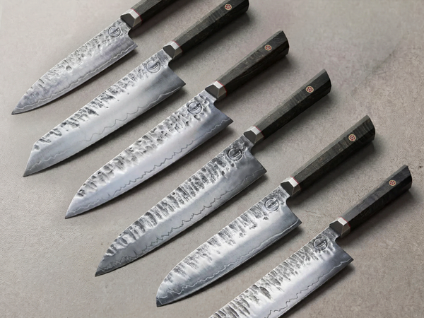 Hand forged knife set: six Bara Forge blades in layered forged steel with burl wood handles
