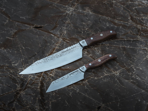Hand-forged chef knives lined up on a cutting board, the best chef knives for 2026