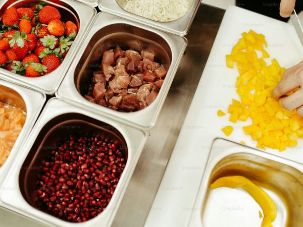 Mise en place tools set out for prep: a hand-forged chef knife, cutting board and stacking bowls
